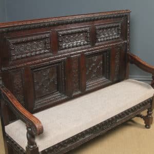 Antique English 17th Century Style Victorian Oak Carved High Back Panelled Upholstered Settle (Circa 1870)